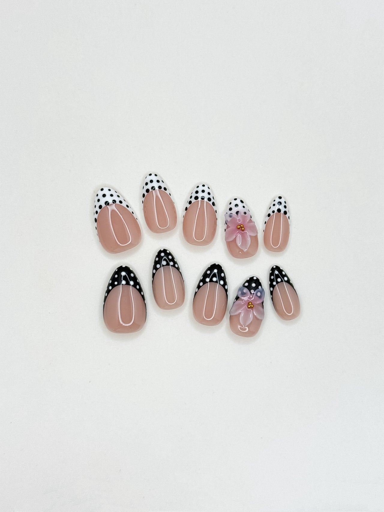 Glossy nude and mocha brown floral press-on nails featuring delicate hand-painted flower details, a soft neutral palette, and an elegant almond shape inspired by café tones and vintage femininity.