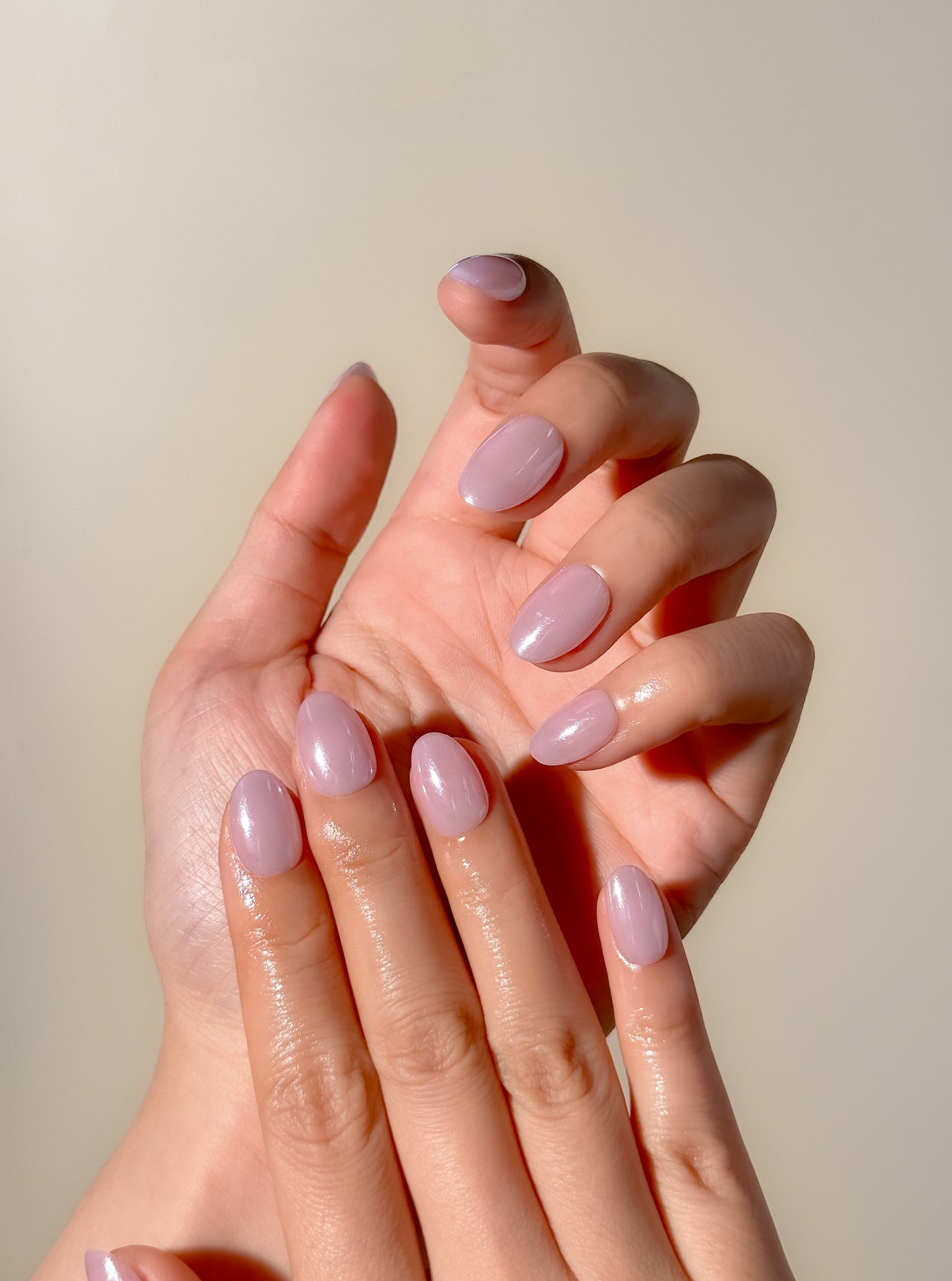 Lavender glazed press-on nails in an extra short oval shape with a glossy pastel lilac finish. Handmade reusable false nails inspired by clean girl nails, soft pastel manicures and minimalist glazed nail trends.