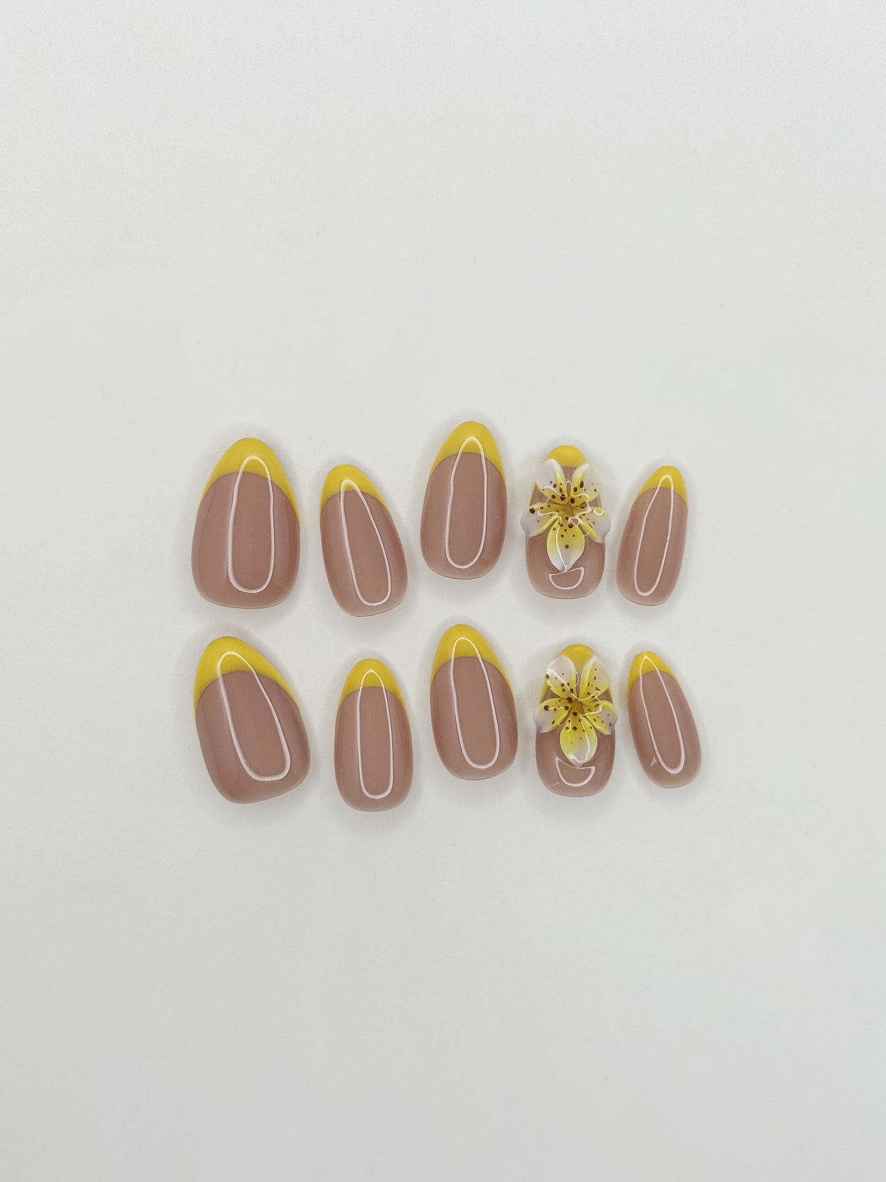 Fresh lemon-yellow French tip press-on nails with a glossy finish, featuring a soft almond shape and a clean citrus-inspired design for a playful yet elevated look.