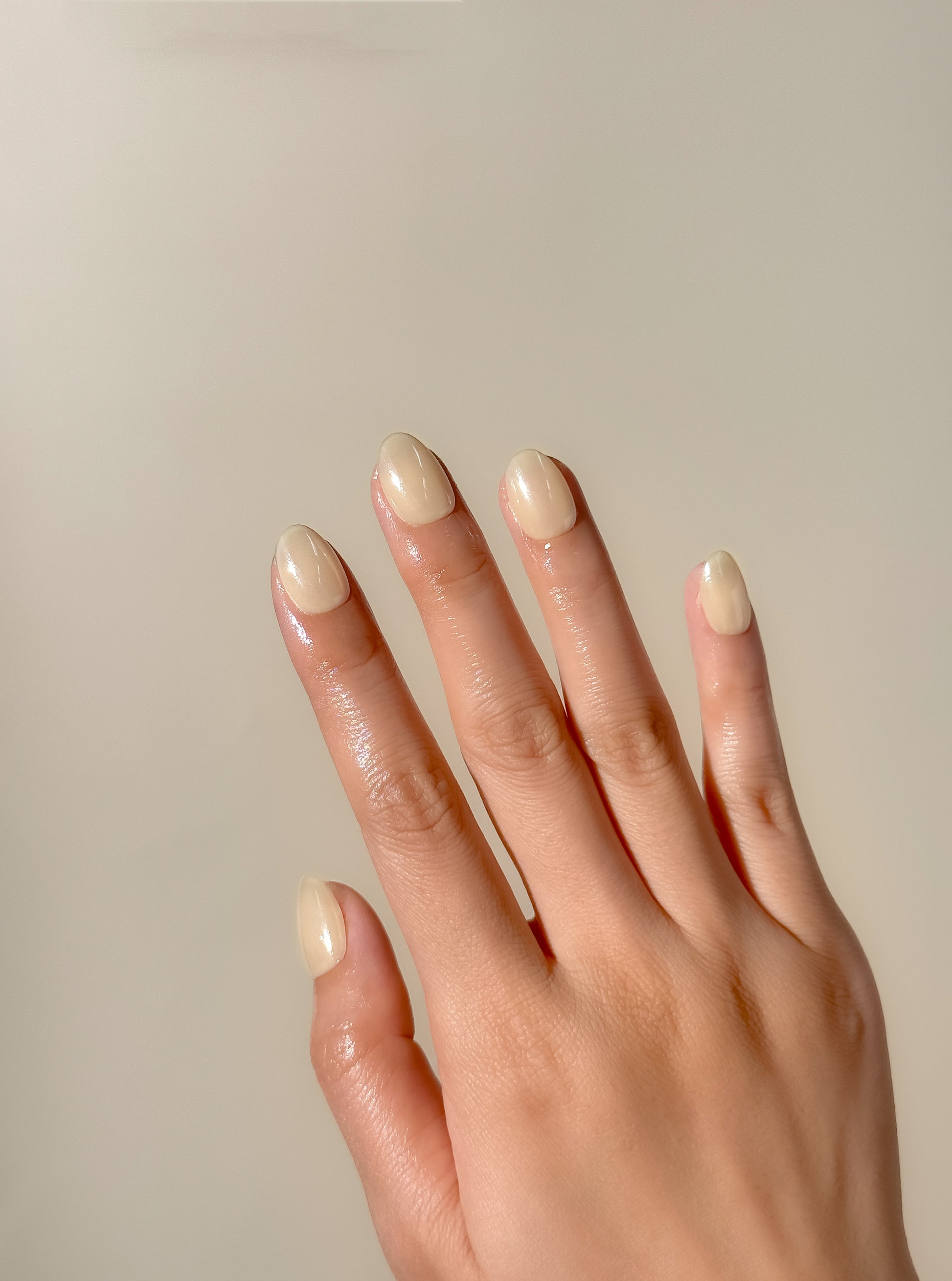 Butter yellow glazed press-on nails in an extra short oval shape with a glossy creamy finish. Handmade reusable false nails inspired by butter yellow nails, soft pastel manicures and clean girl summer nail trends.