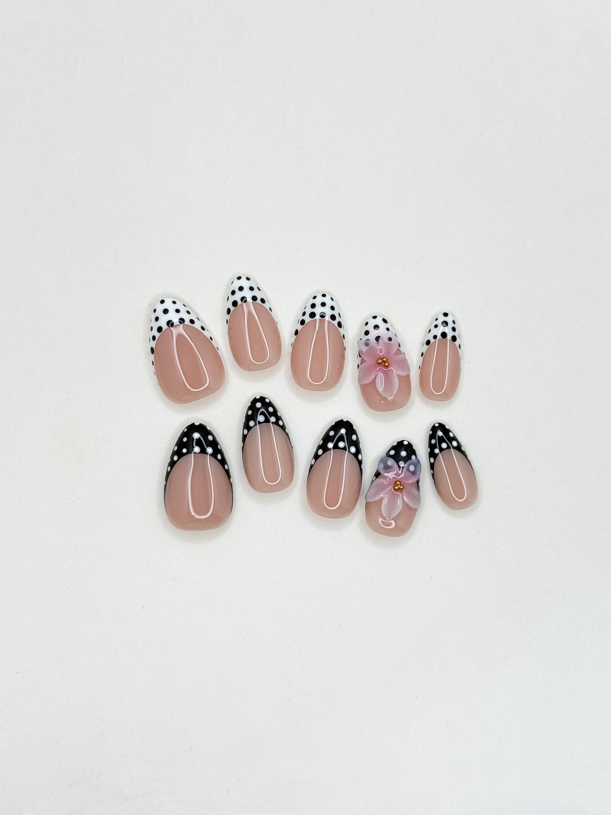 Glossy nude and mocha brown floral press-on nails featuring delicate hand-painted flower details, a soft neutral palette, and an elegant almond shape inspired by café tones and vintage femininity.