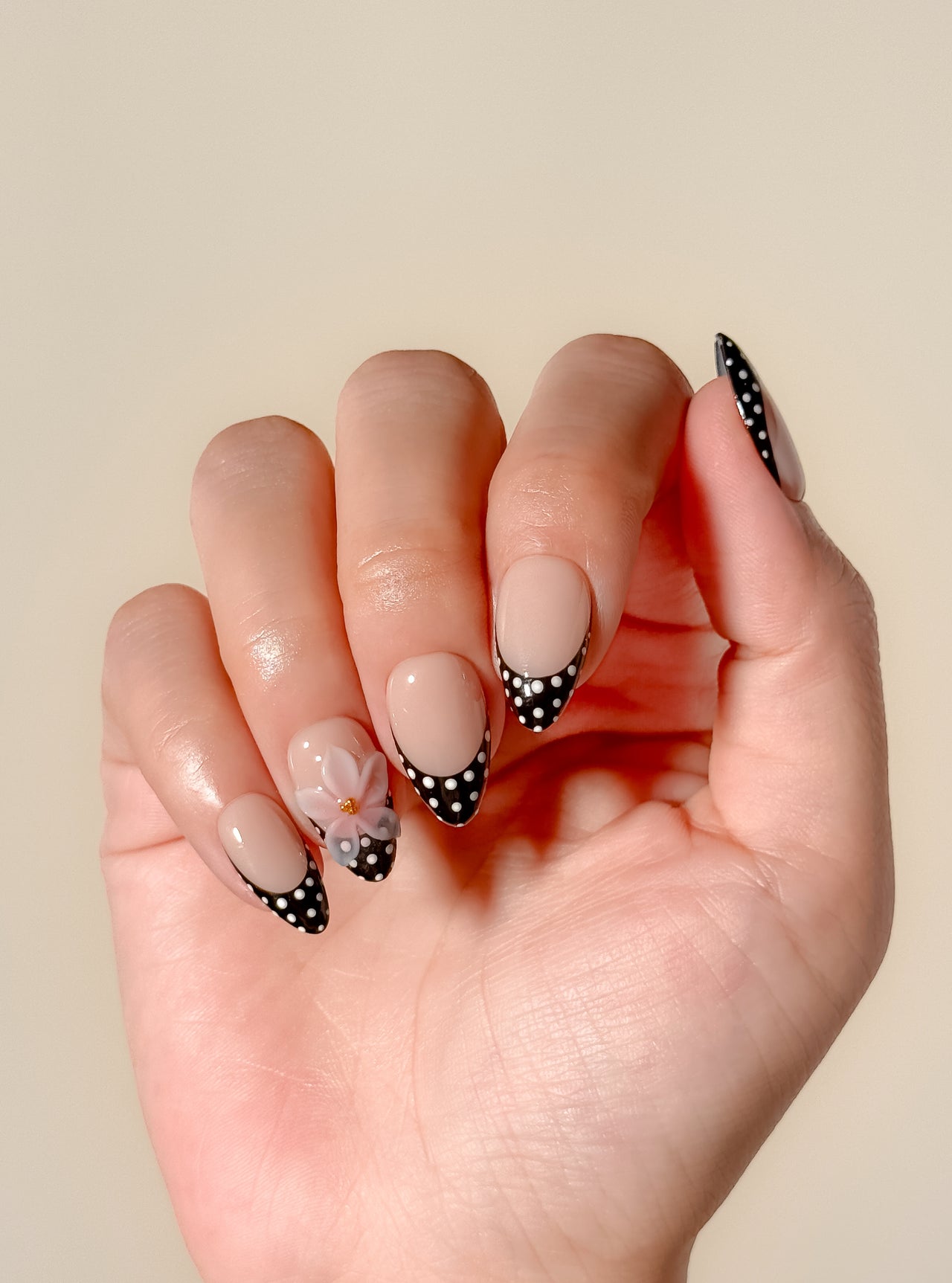 Glossy nude and mocha brown floral press-on nails featuring delicate hand-painted flower details, a soft neutral palette, and an elegant almond shape inspired by café tones and vintage femininity.