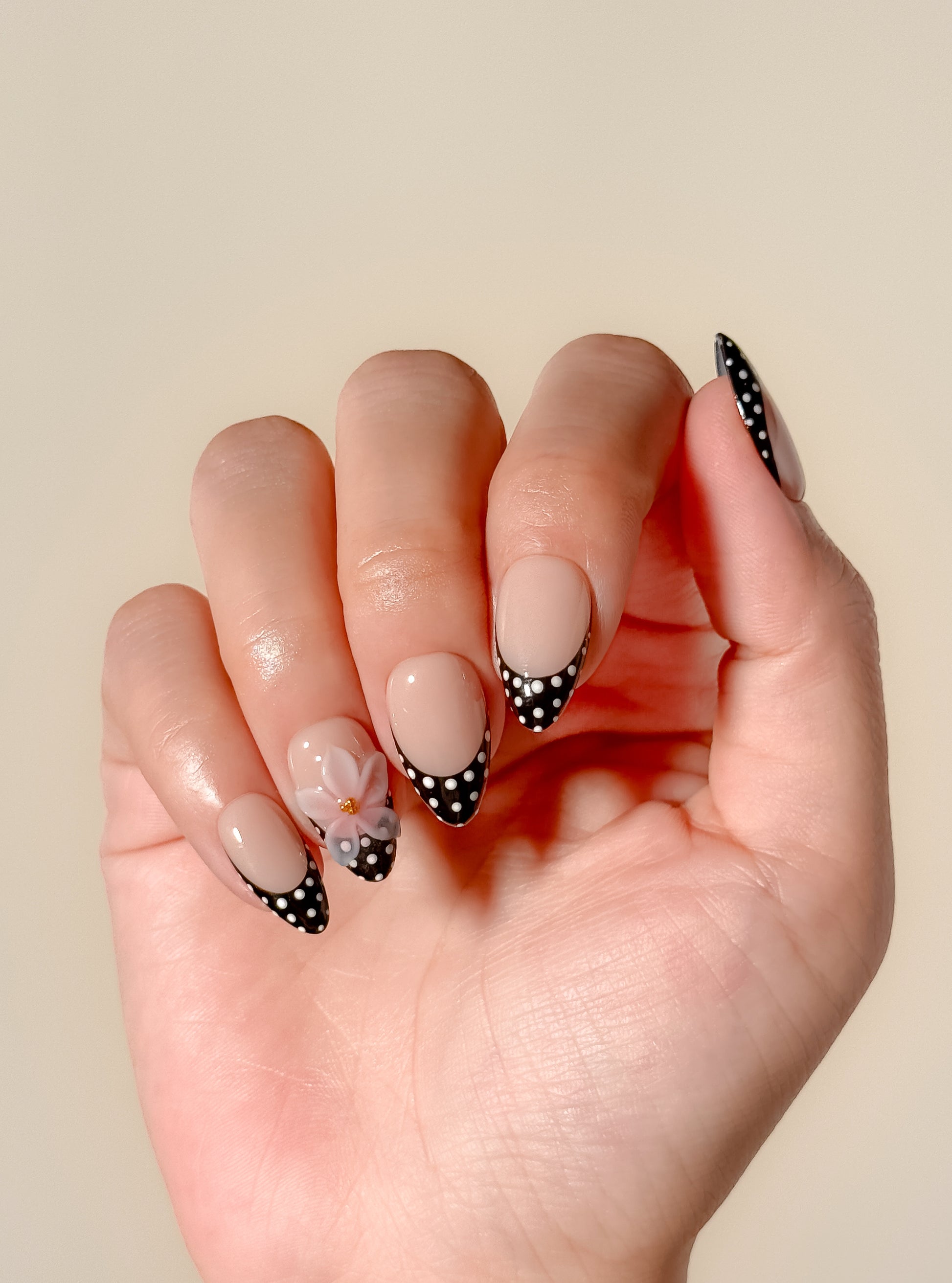 Glossy nude and mocha brown floral press-on nails featuring delicate hand-painted flower details, a soft neutral palette, and an elegant almond shape inspired by café tones and vintage femininity.
