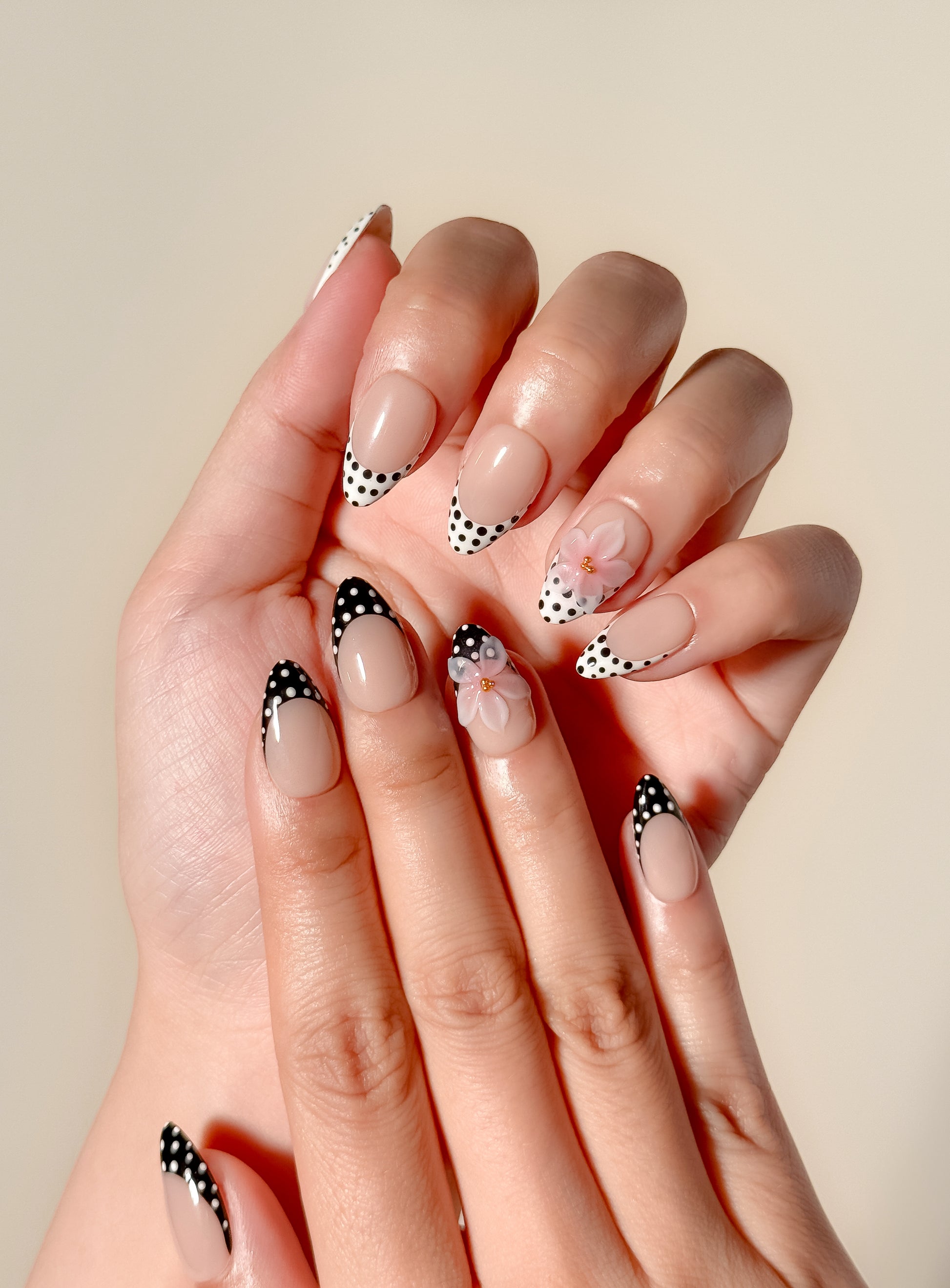 Glossy nude and mocha brown floral press-on nails featuring delicate hand-painted flower details, a soft neutral palette, and an elegant almond shape inspired by café tones and vintage femininity.