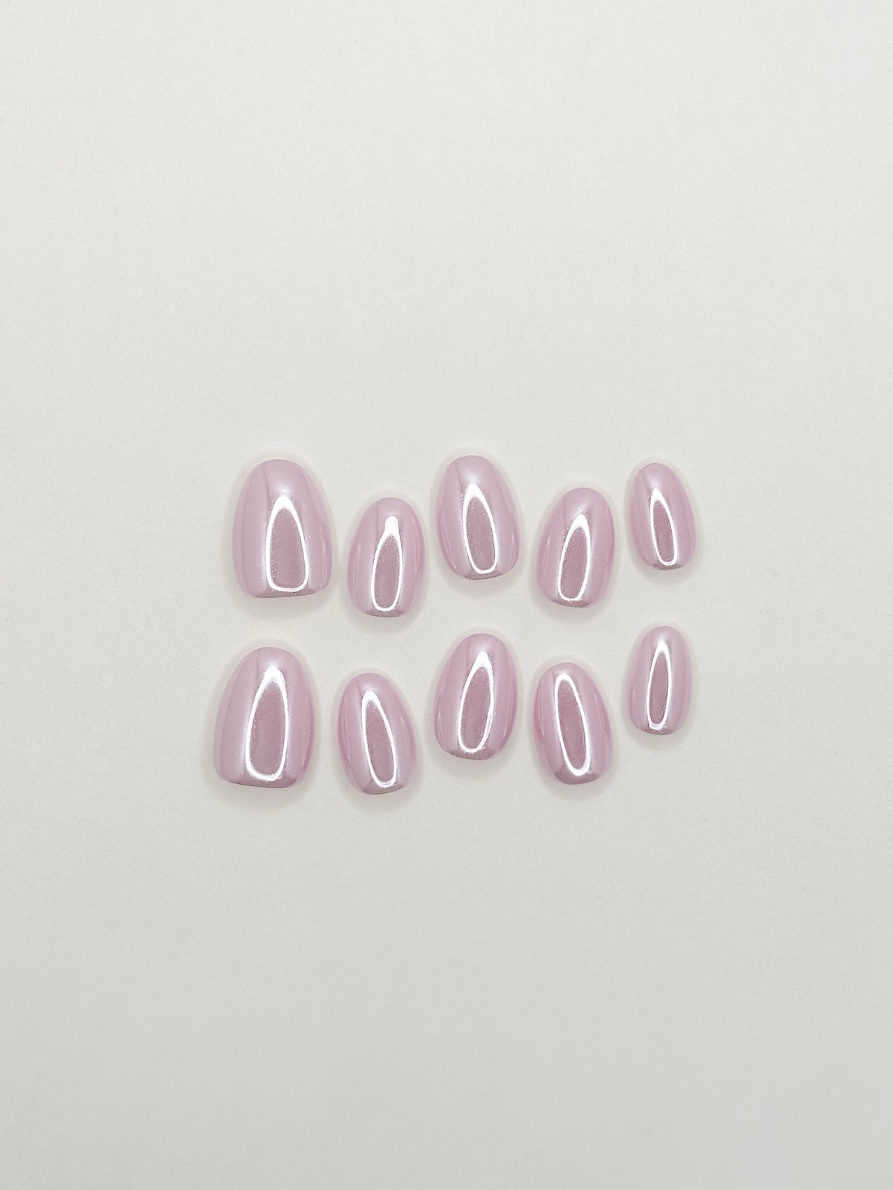 Lavender glazed press-on nails in an extra short oval shape with a glossy pastel lilac finish. Handmade reusable false nails inspired by clean girl nails, soft pastel manicures and minimalist glazed nail trends.