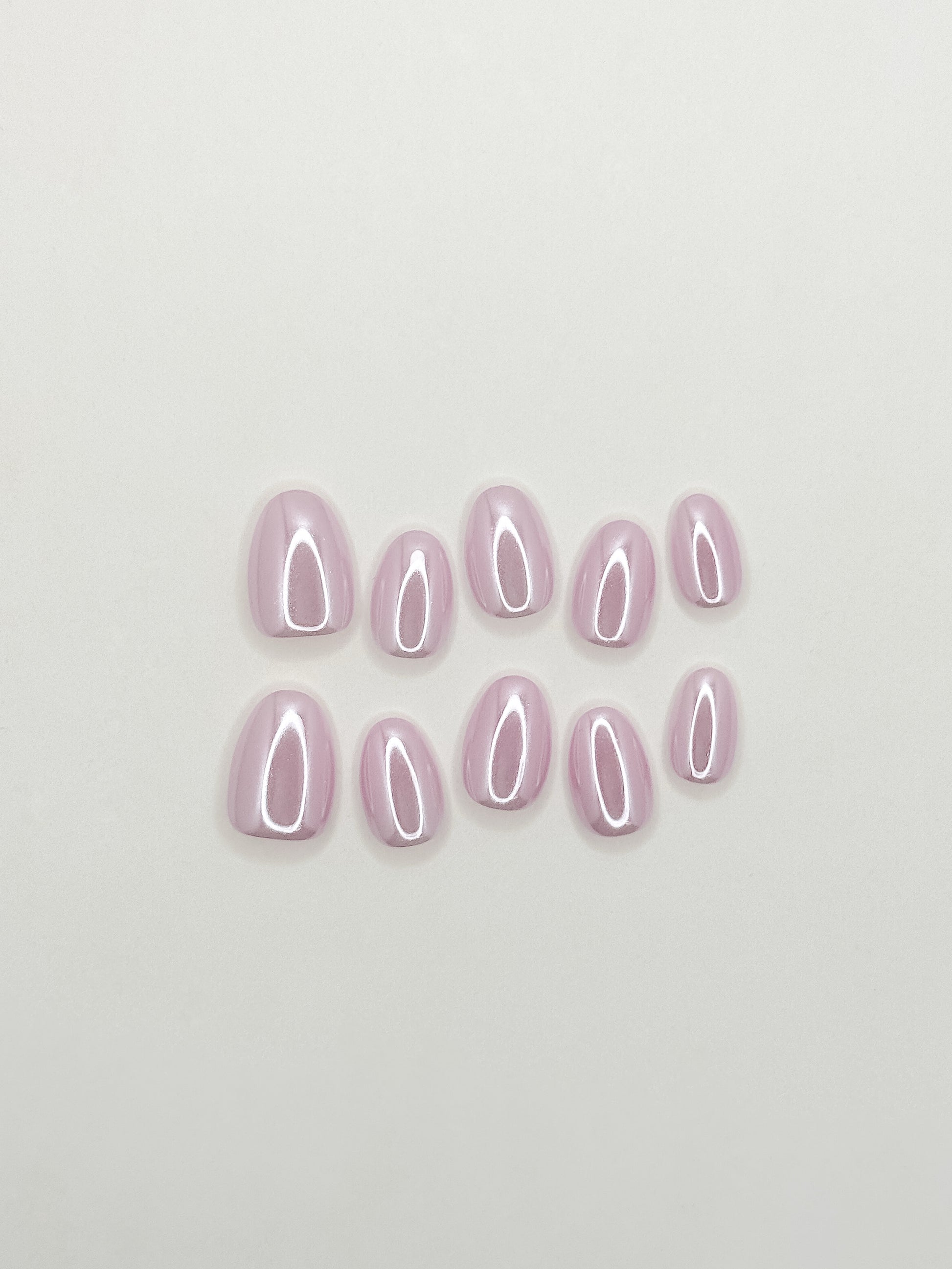 Lavender glazed press-on nails in an extra short oval shape with a glossy pastel lilac finish. Handmade reusable false nails inspired by clean girl nails, soft pastel manicures and minimalist glazed nail trends.