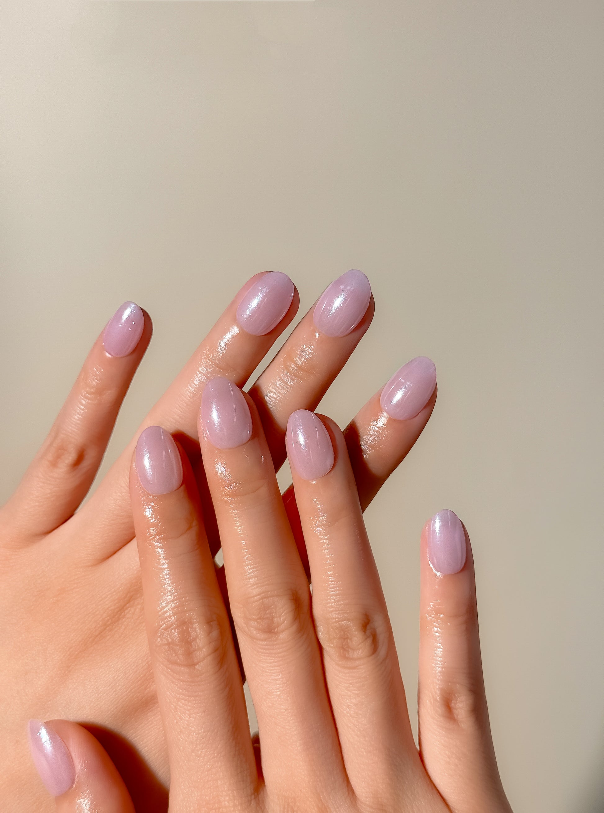 Lavender glazed press-on nails in an extra short oval shape with a glossy pastel lilac finish. Handmade reusable false nails inspired by clean girl nails, soft pastel manicures and minimalist glazed nail trends.