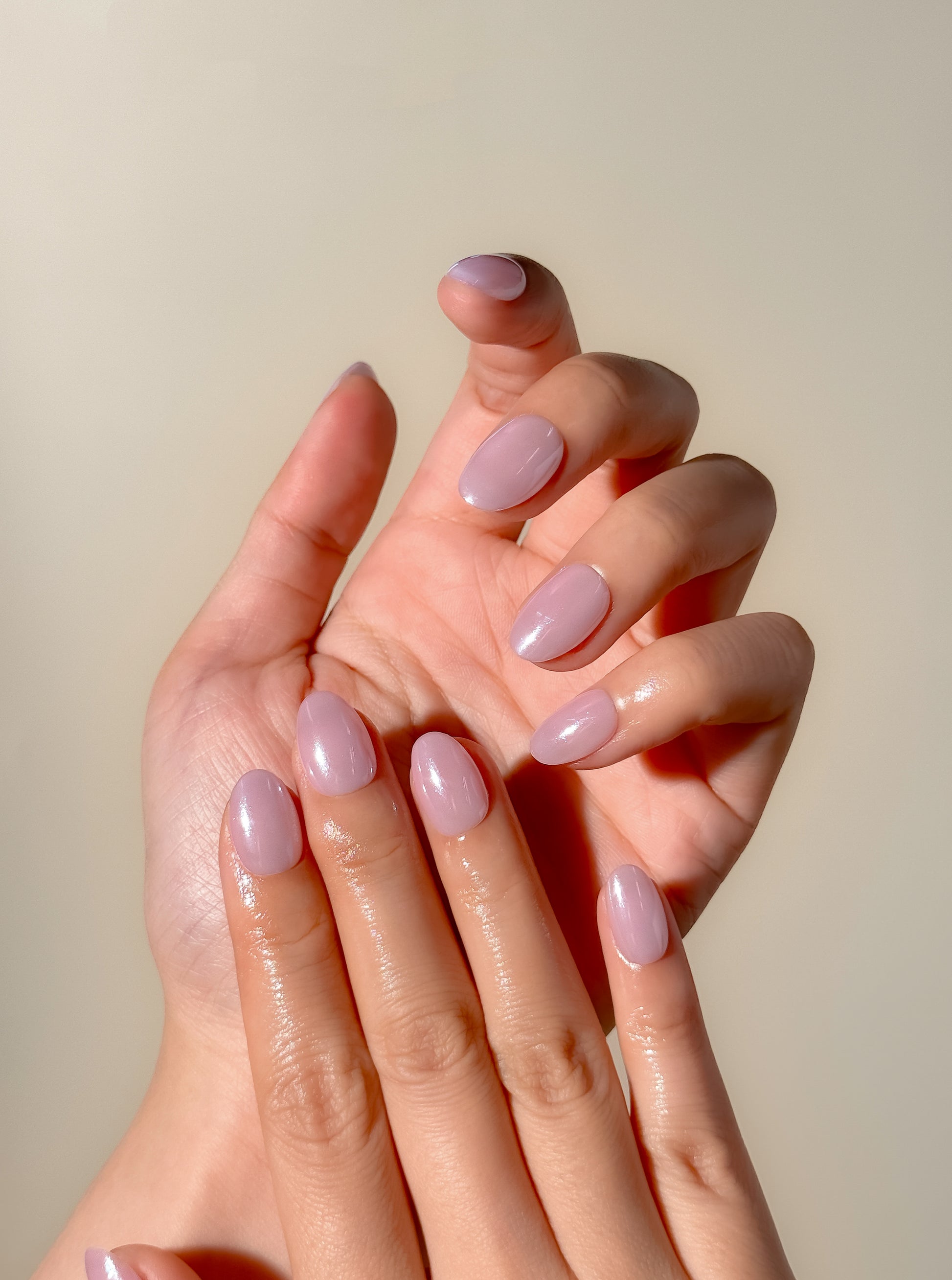 Lavender glazed press-on nails in an extra short oval shape with a glossy pastel lilac finish. Handmade reusable false nails inspired by clean girl nails, soft pastel manicures and minimalist glazed nail trends.