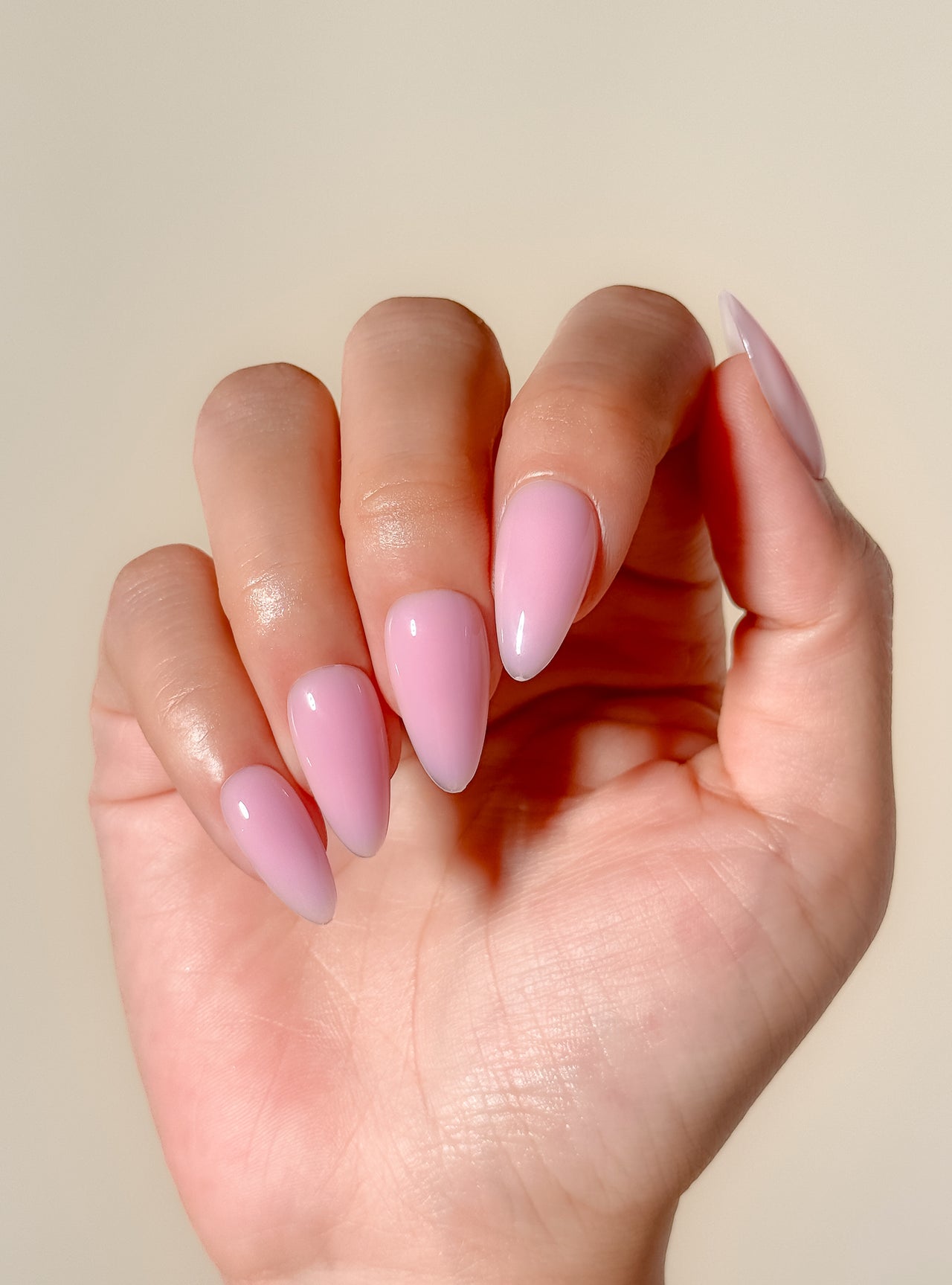 Glossy soft pink ombré press-on nails in a medium almond shape with a creamy gelato-inspired finish. Handmade reusable false nails featuring blended rosy nude tones for a clean, feminine and elevated everyday manicure.