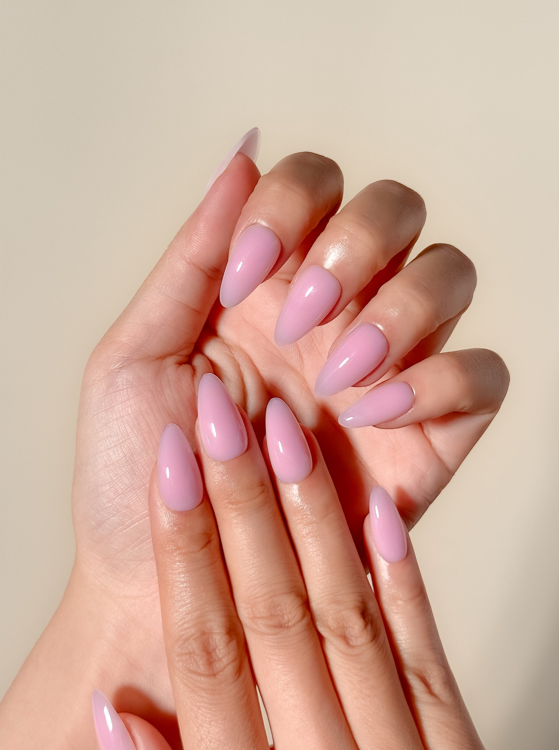 Glossy soft pink ombré press-on nails in a medium almond shape with a creamy gelato-inspired finish. Handmade reusable false nails featuring blended rosy nude tones for a clean, feminine and elevated everyday manicure.