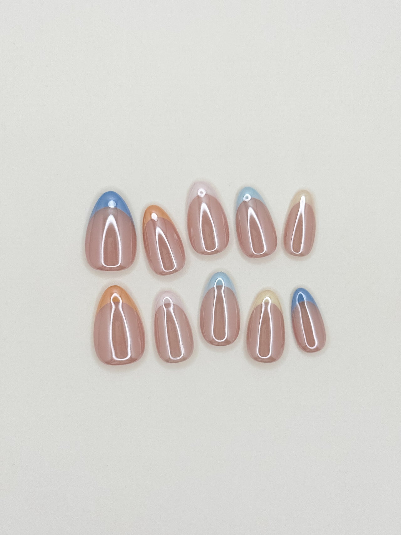 Soft sorbet pink French tip press-on nails with a glazed finish, featuring a minimal almond silhouette and a clean modern design for an effortless everyday look.