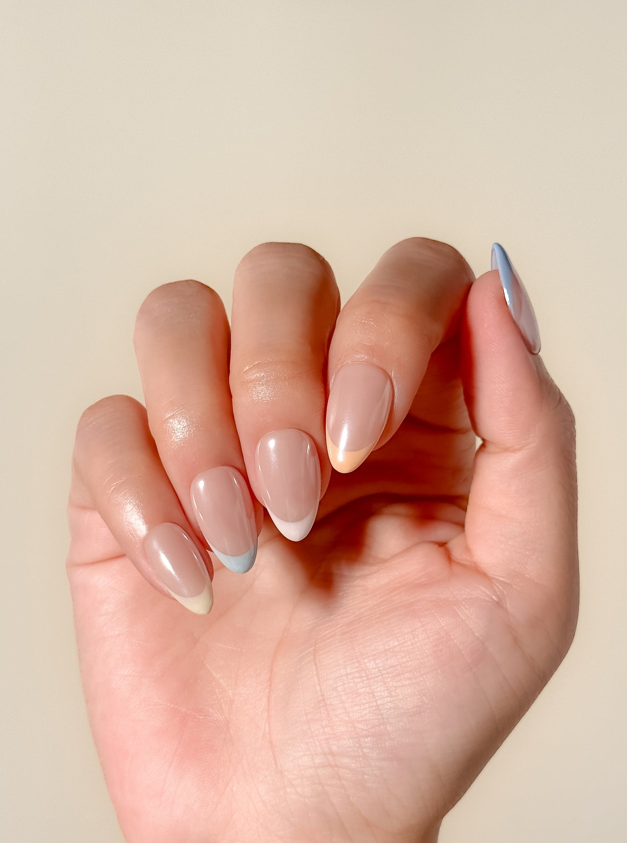 Soft sorbet pink French tip press-on nails with a glazed finish, featuring a minimal almond silhouette and a clean modern design for an effortless everyday look.