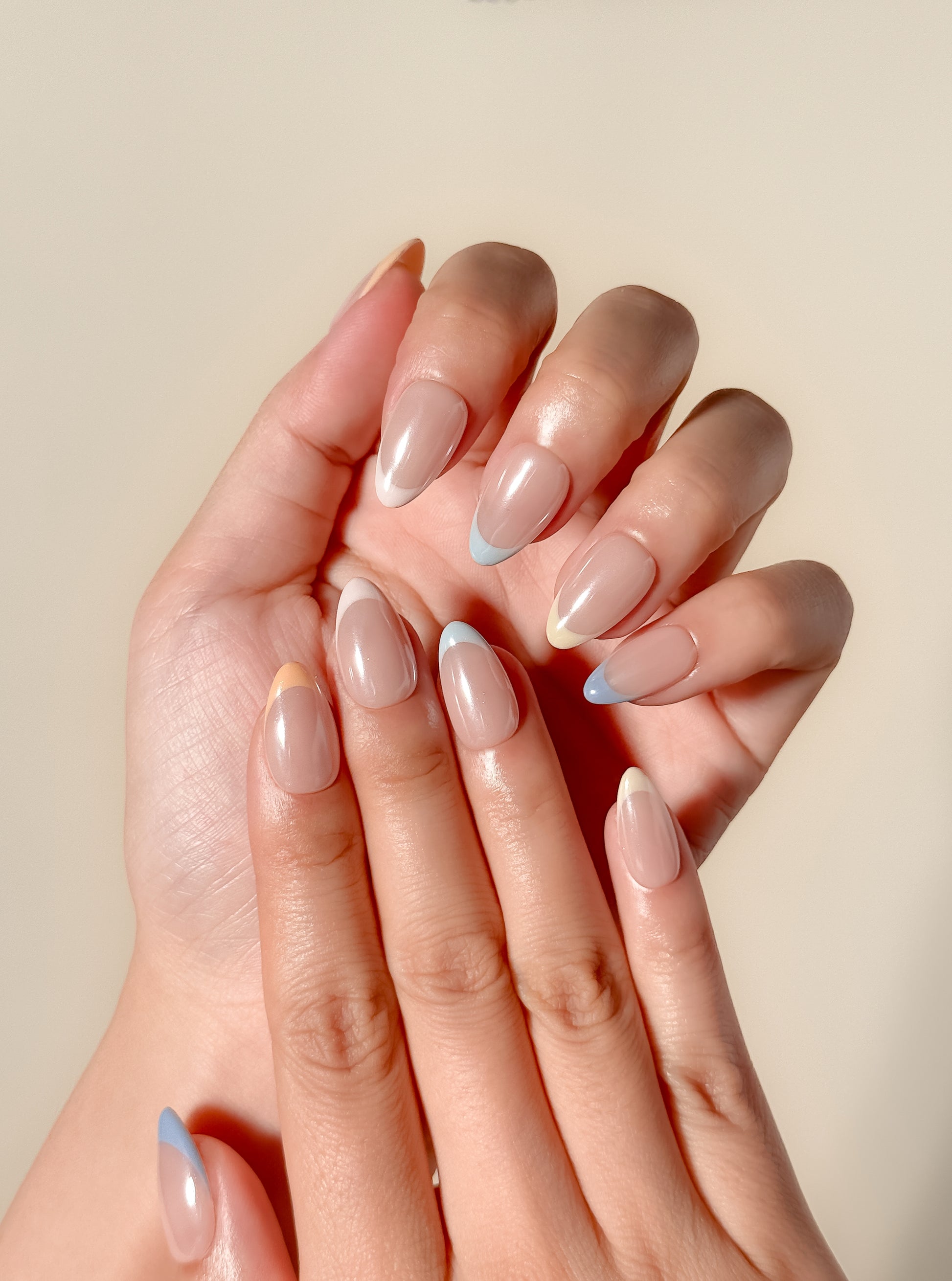 Soft sorbet pink French tip press-on nails with a glazed finish, featuring a minimal almond silhouette and a clean modern design for an effortless everyday look.