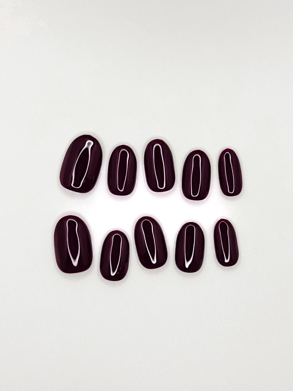 After Work dark cherry burgundy short oval press-on nails arranged as a glossy reusable set on a white background.