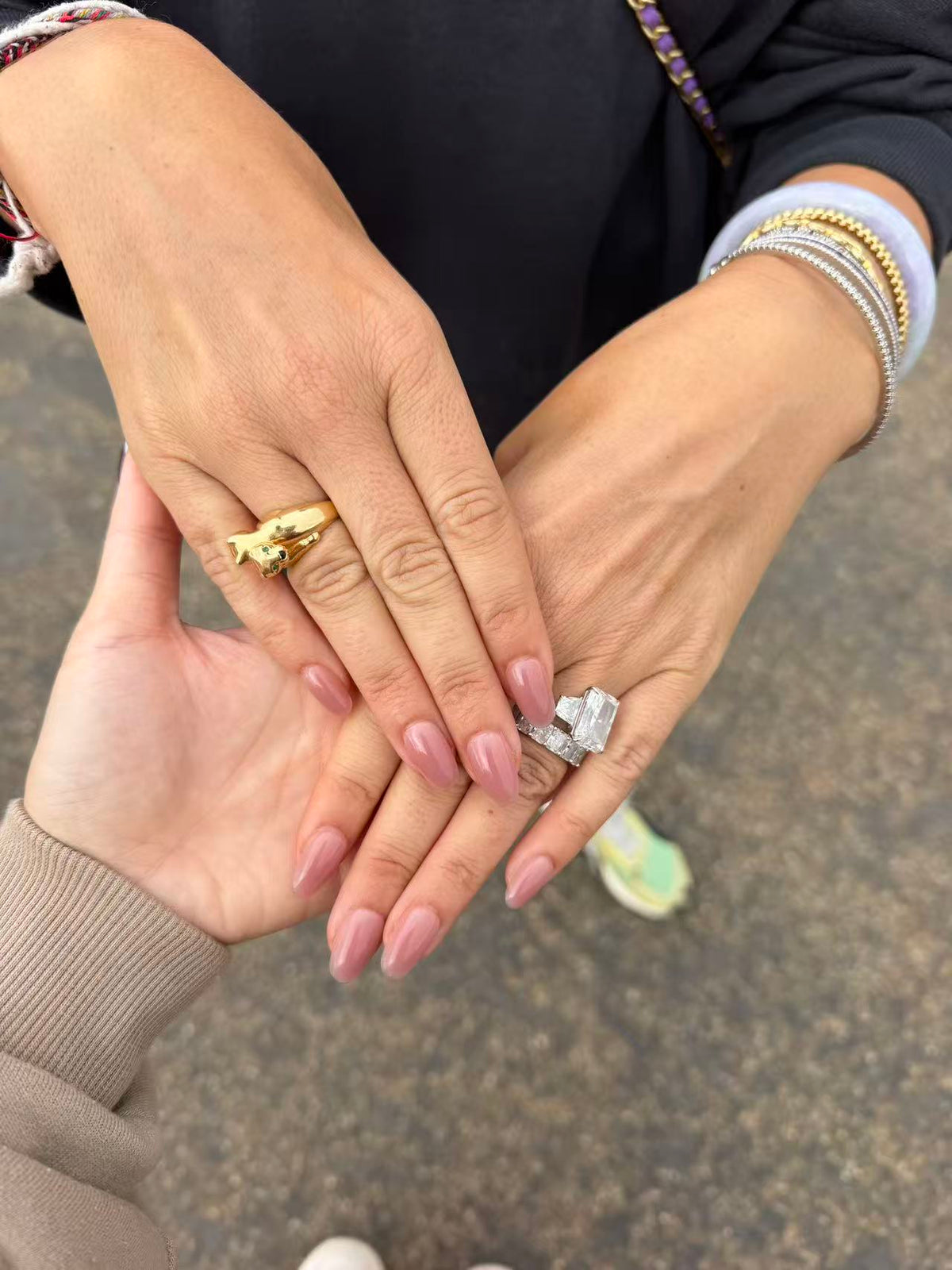 Close-up of hands wearing multiple rings and fette's nude builder gel short oval press on nails