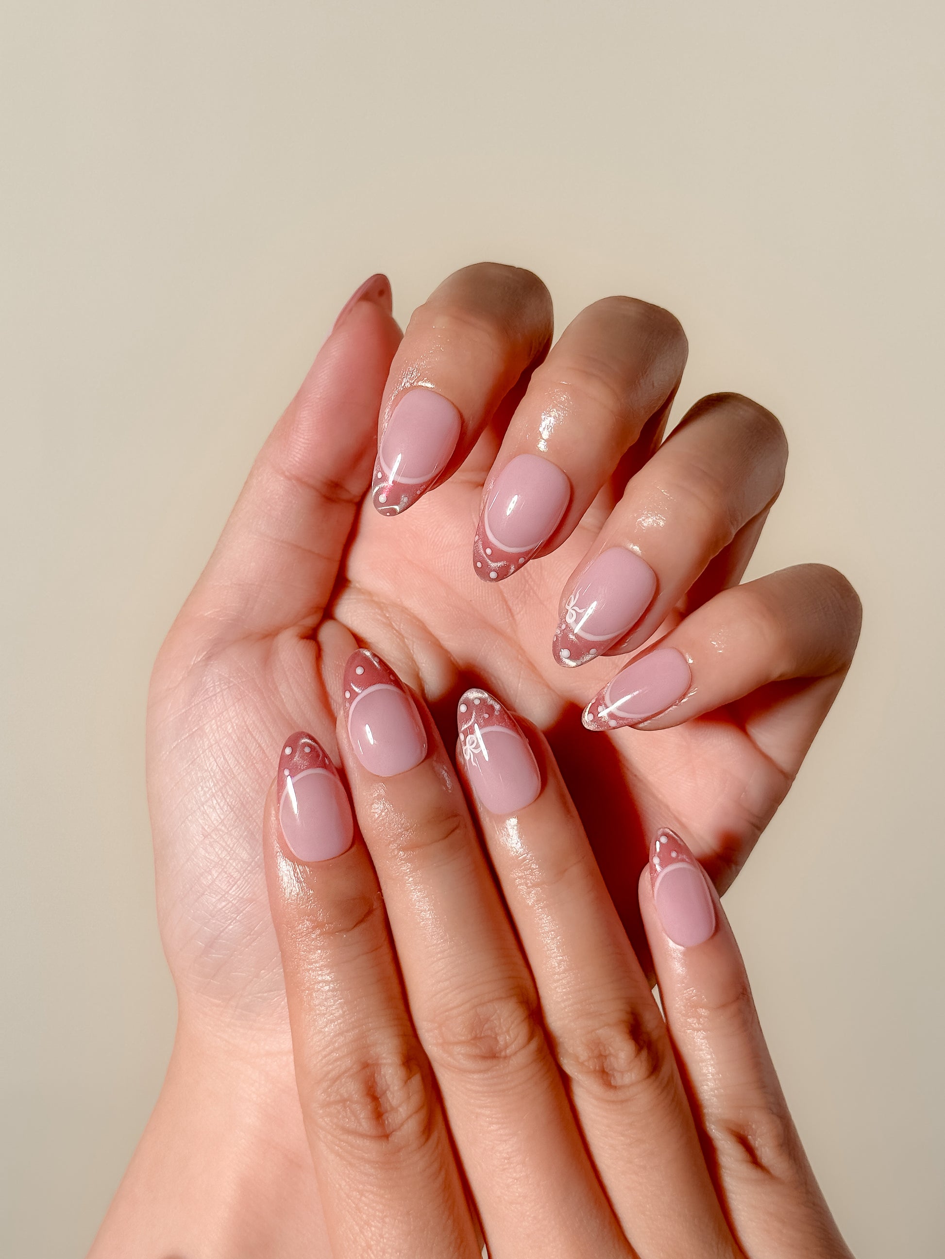 Doe Eyes short almond cat-eye French tip press-on nails with white dot and bow details
