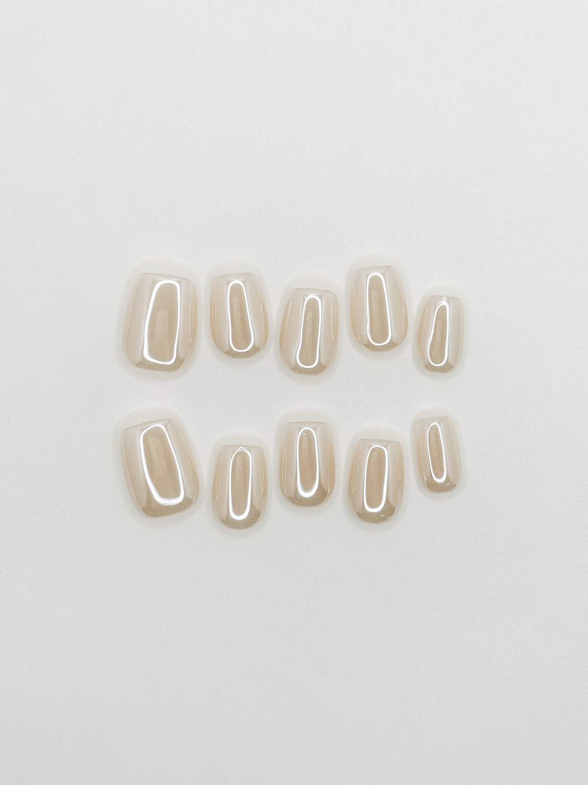 Early Rise milky cream glazed short square press-on nails arranged as a luminous reusable set on a white background.